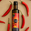 Adelaide Hills Harvest Chilli Press extra virgin olive oil bottle surrounded by fresh red cayenne chillies