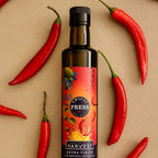 Adelaide Hills Harvest Chilli Press extra virgin olive oil bottle surrounded by fresh red cayenne chillies