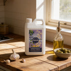 Adelaide Hills Harvest 2L bottle of cold-pressed garlic infused extra virgin olive oil on a rustic wooden kitchen table