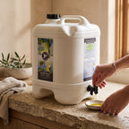Adelaide Hills Harvest 2L white plastic drum of extra virgin olive oil being poured into a small ceramic bowl.